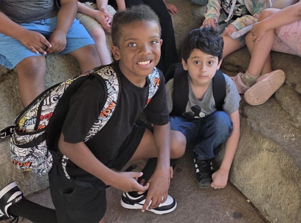 Students pose by animals