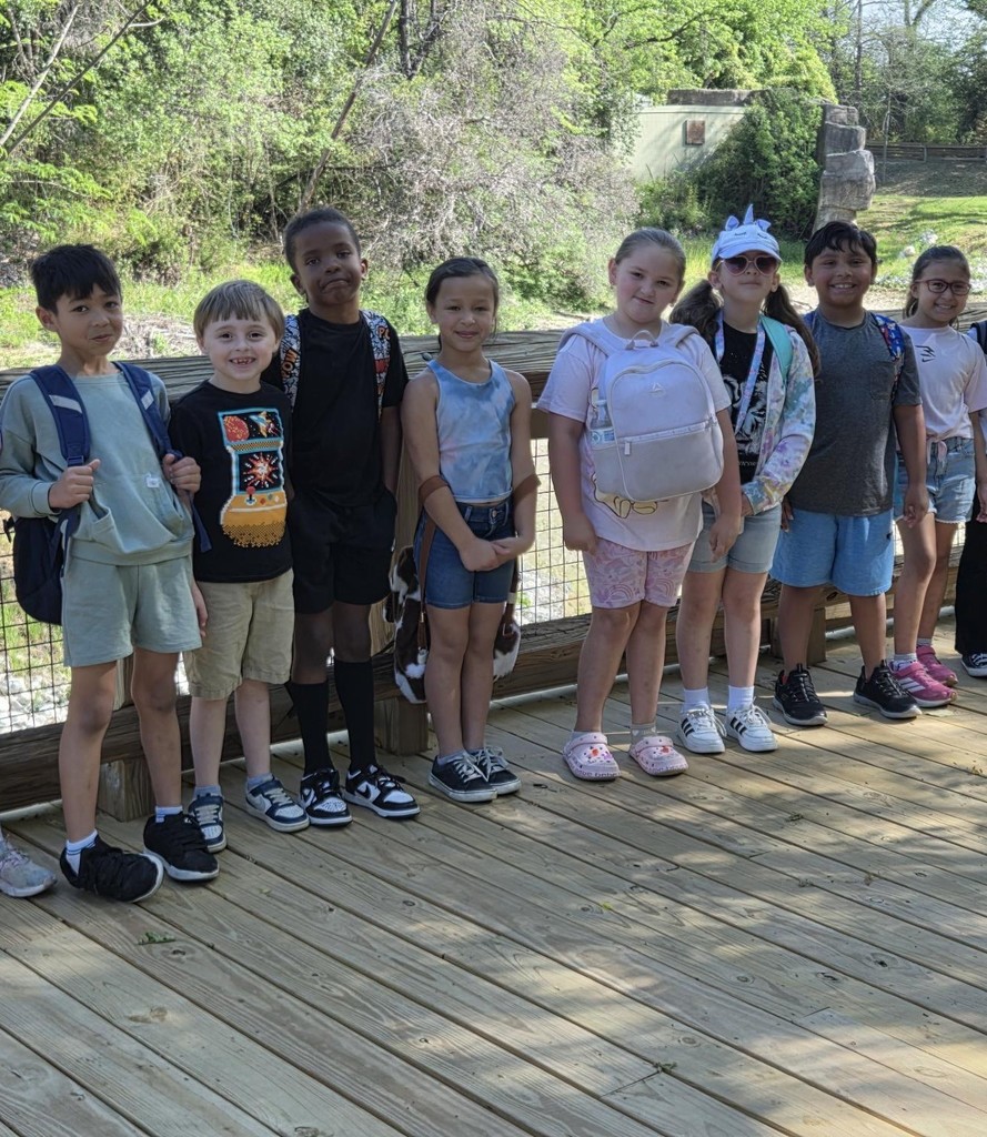 Students pose by animals
