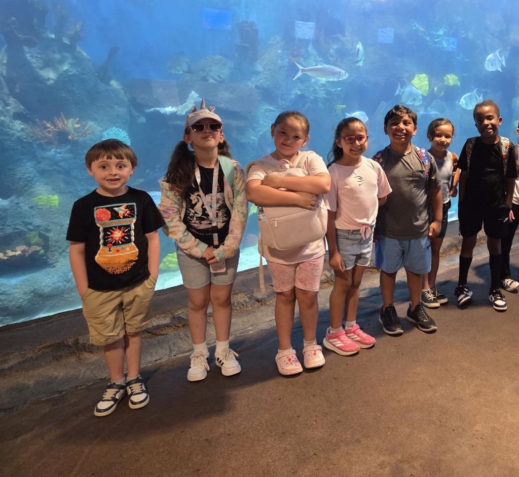 Students pose by animals