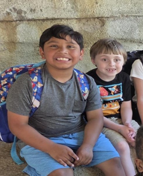 Students pose by animals