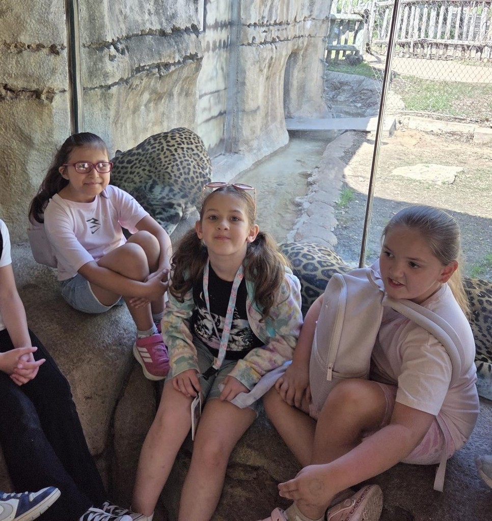 Students pose by animals