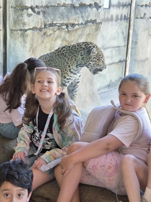 Students pose by animals