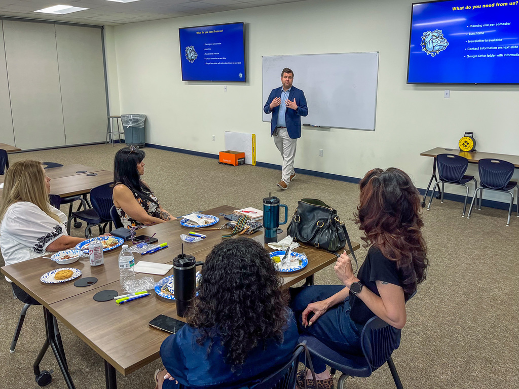 Man speaking to a room of people