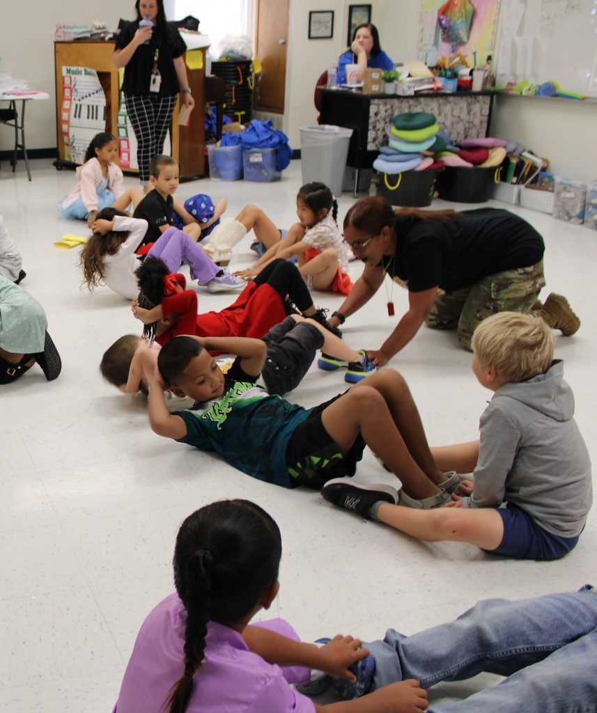 Army presenter leads kinder in sit ups