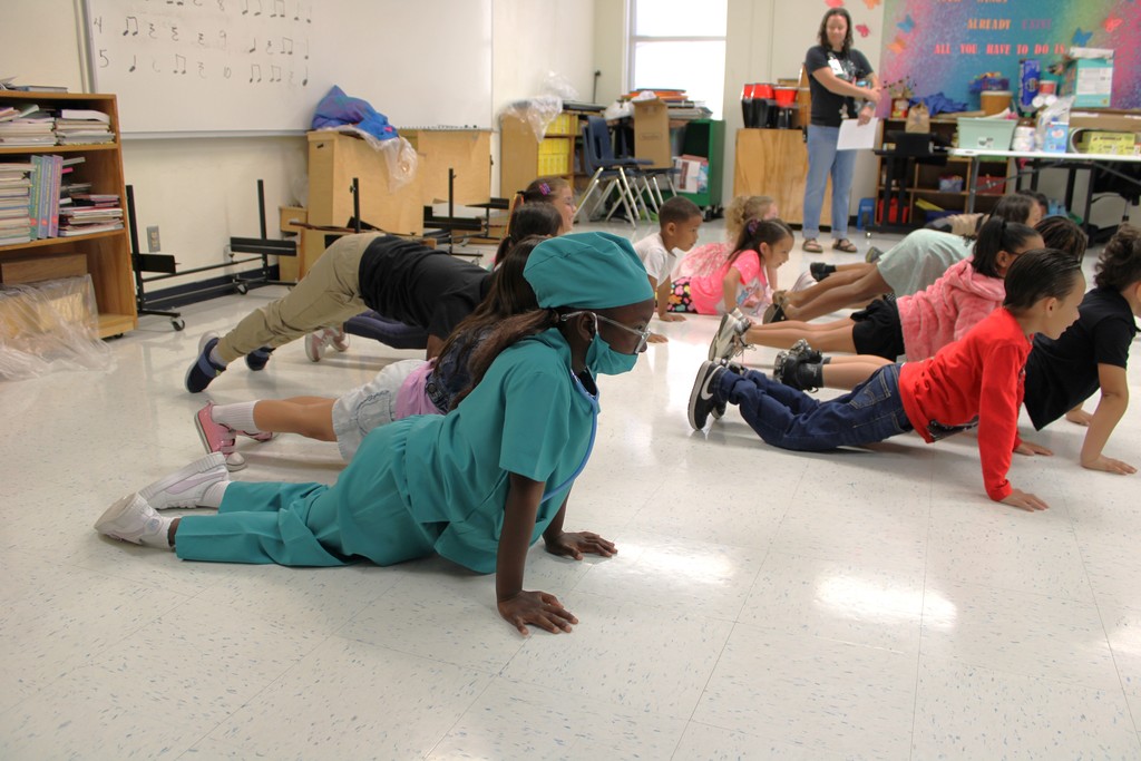 Kinder students do push ups