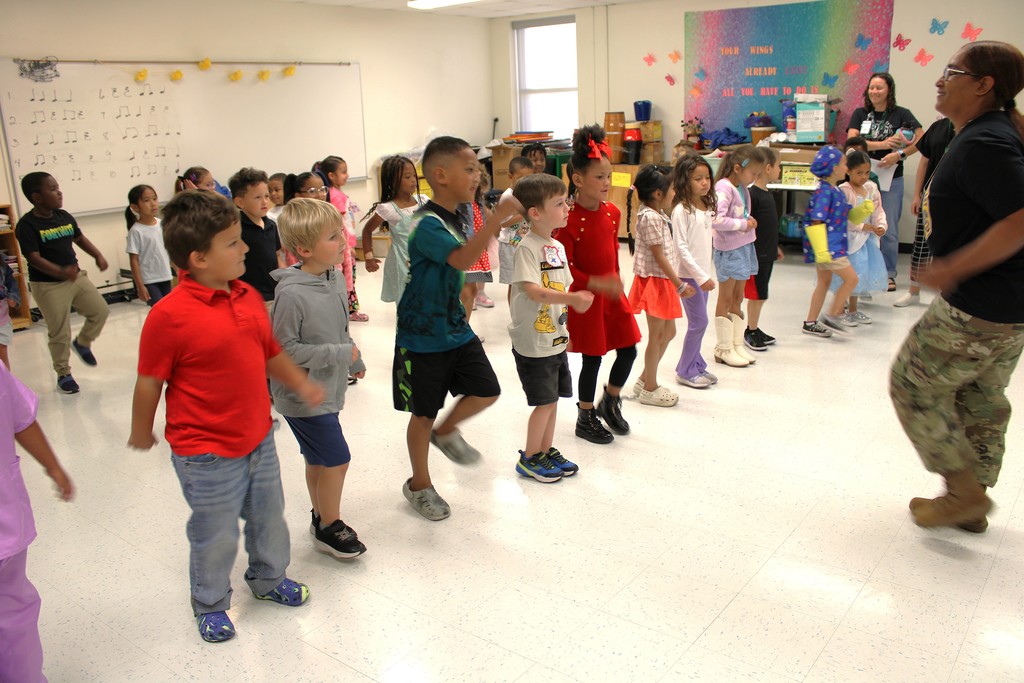 Army presenter leads kinder in march to cadence