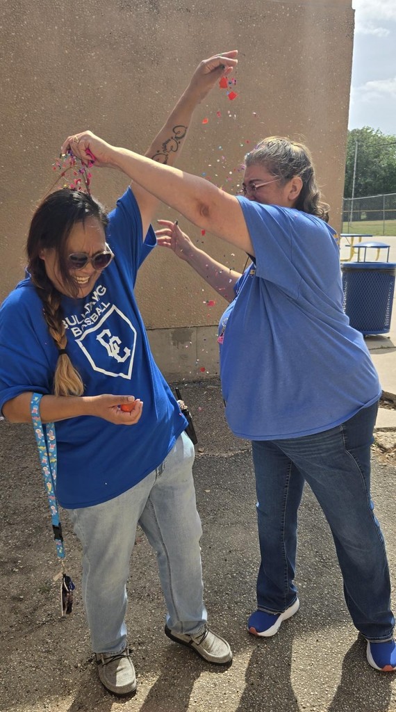Ms. Garner and Mrs. Morgan smash confetti eggs on each other.