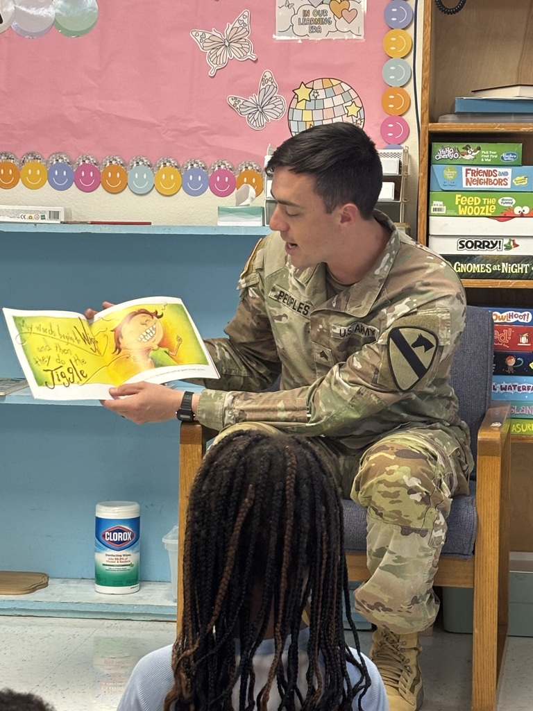 Soldier reading to students