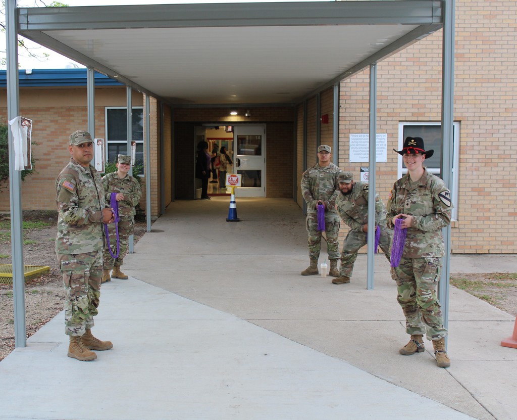 Soldiers pose as they get ready to greet students