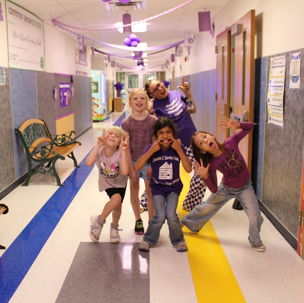 Students pose with Teachers in purple up day gear
