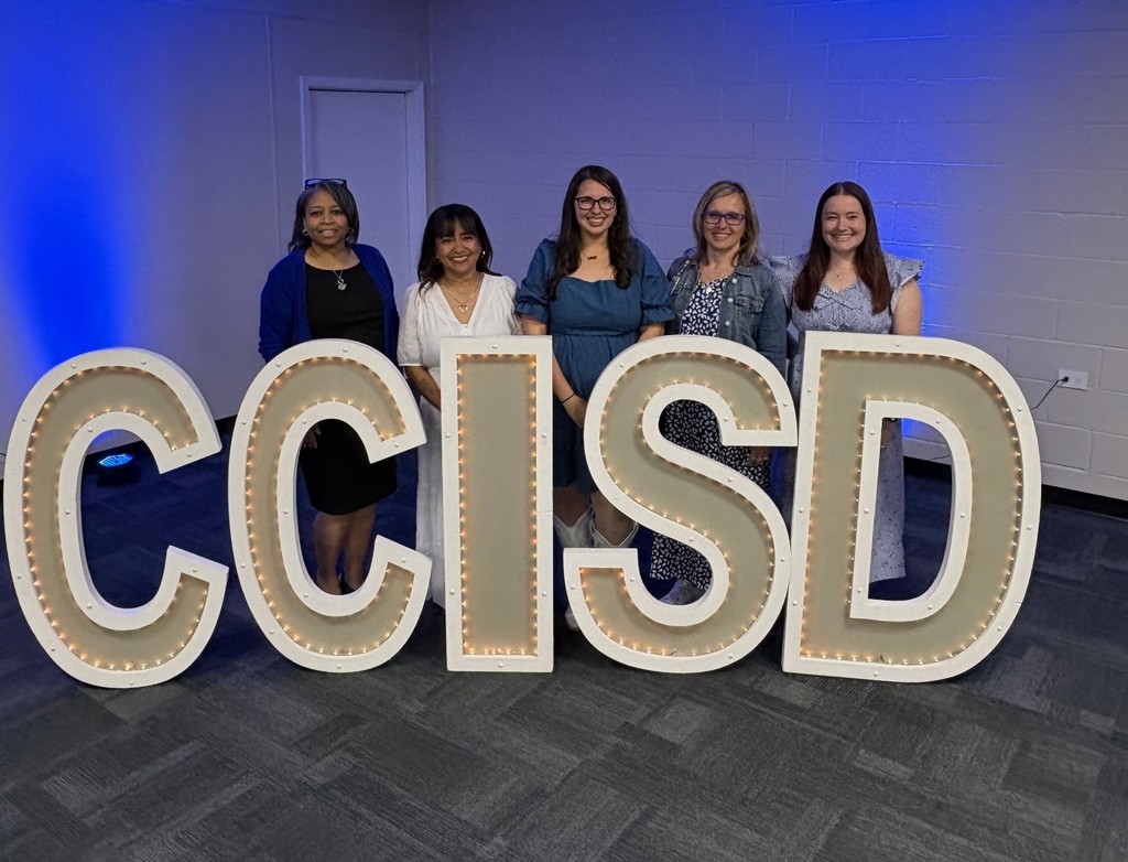 Admin and winners of Teacher/ Para of the year pose by CCISD marquee letters