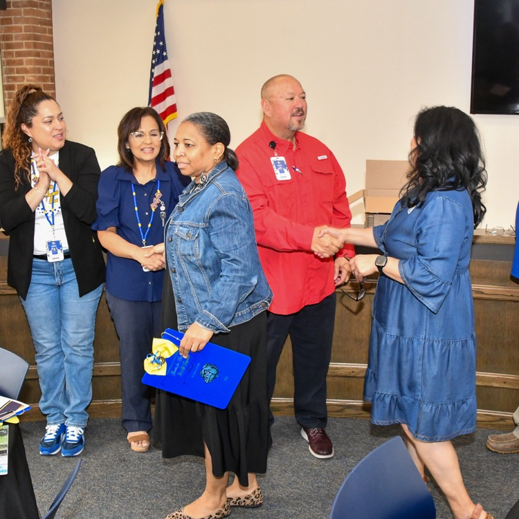A group of people shaking hands and smiling