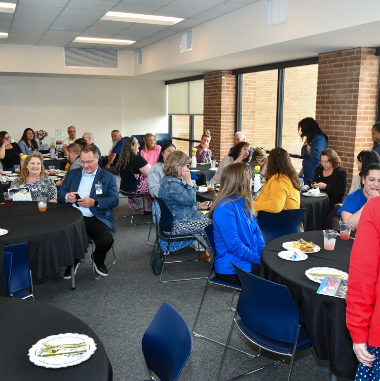 A group of people sitting at tables in a room