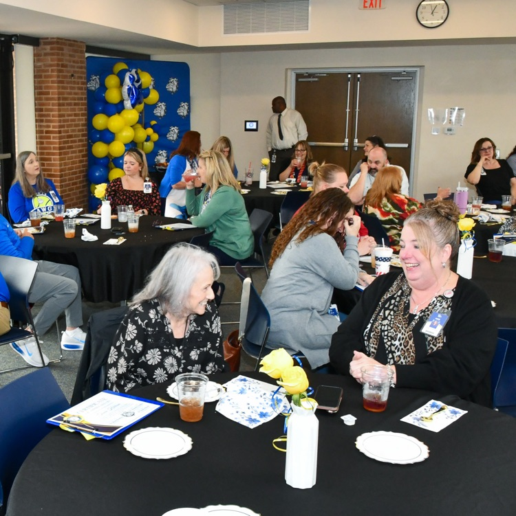A group of people sitting at tables in a room