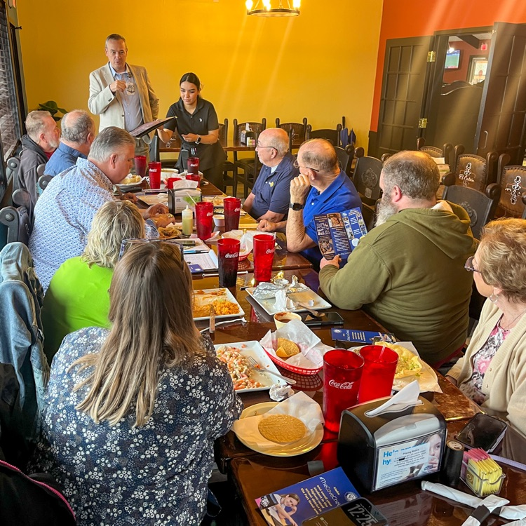 A man speaking to a room of people