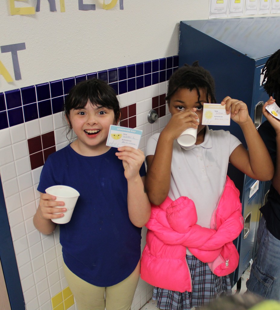 students smile and pose with lemonade
