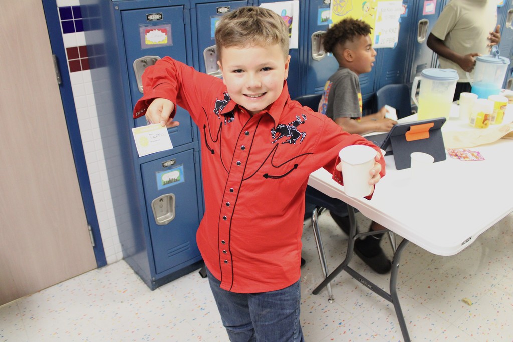 student smile and pose with lemonade