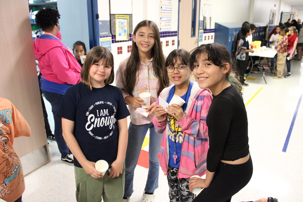 students smile and pose with lemonade