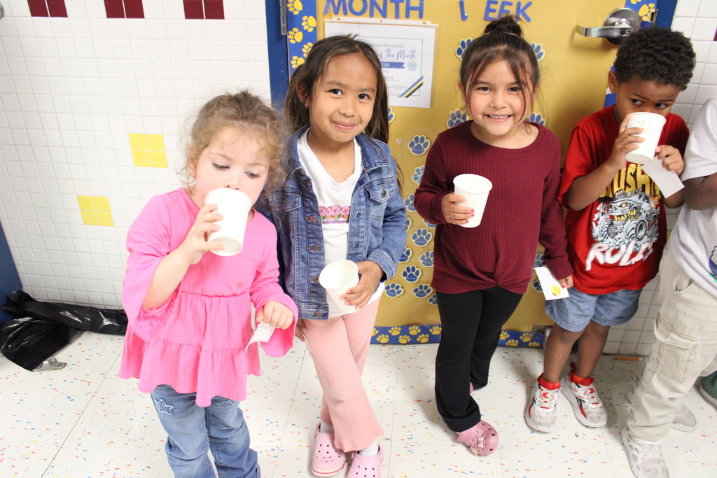 students smile and pose with lemonade