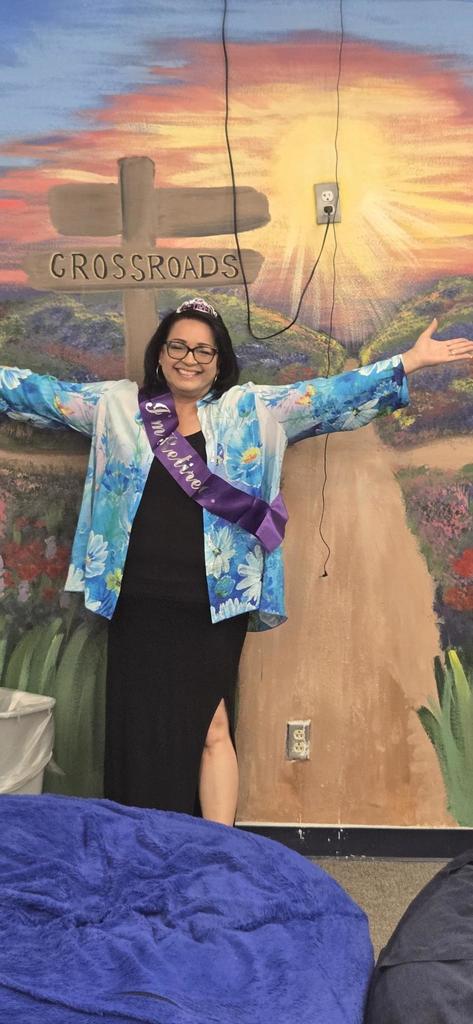 Mrs. Smith in front of mural she painted for 300 room