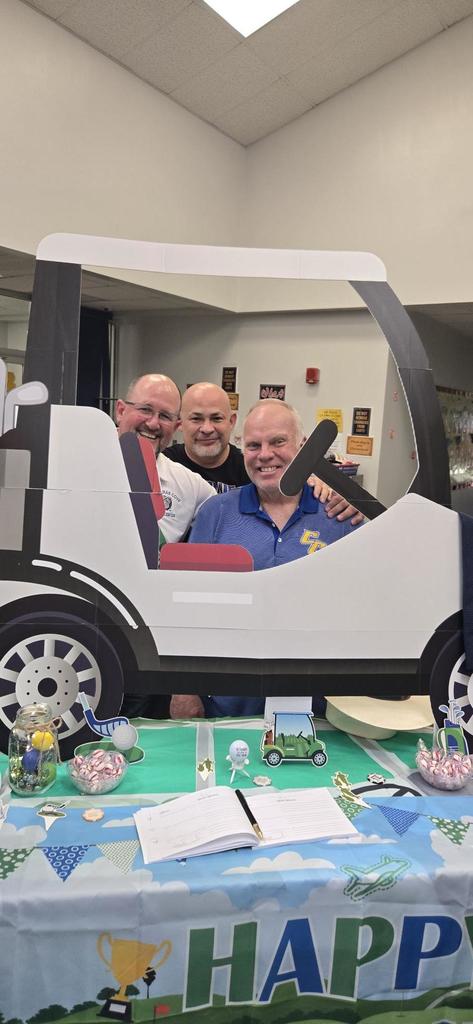Mr. Love, Mr Crawley and Mr Alaniz behind the golf cart display