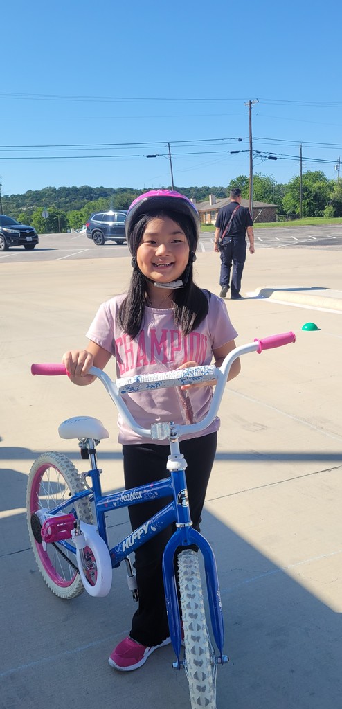 Student smiles with bicycle