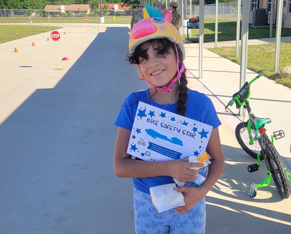 Student poses with Bike Rodeo certificate