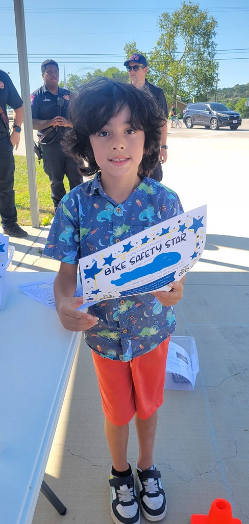 Student poses with Bike Rodeo certificate