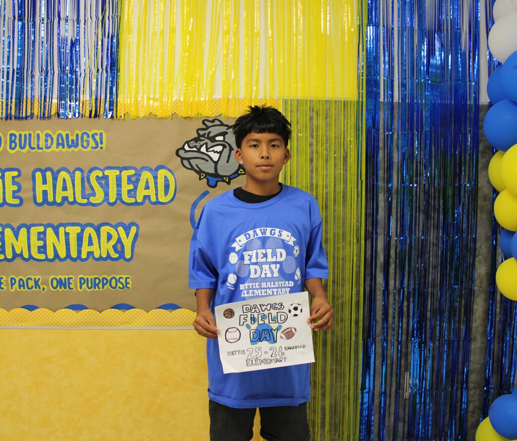 Student in field day shirt poses with his design