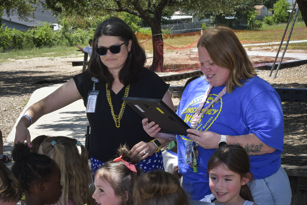 Teacher receiving certificate from principal