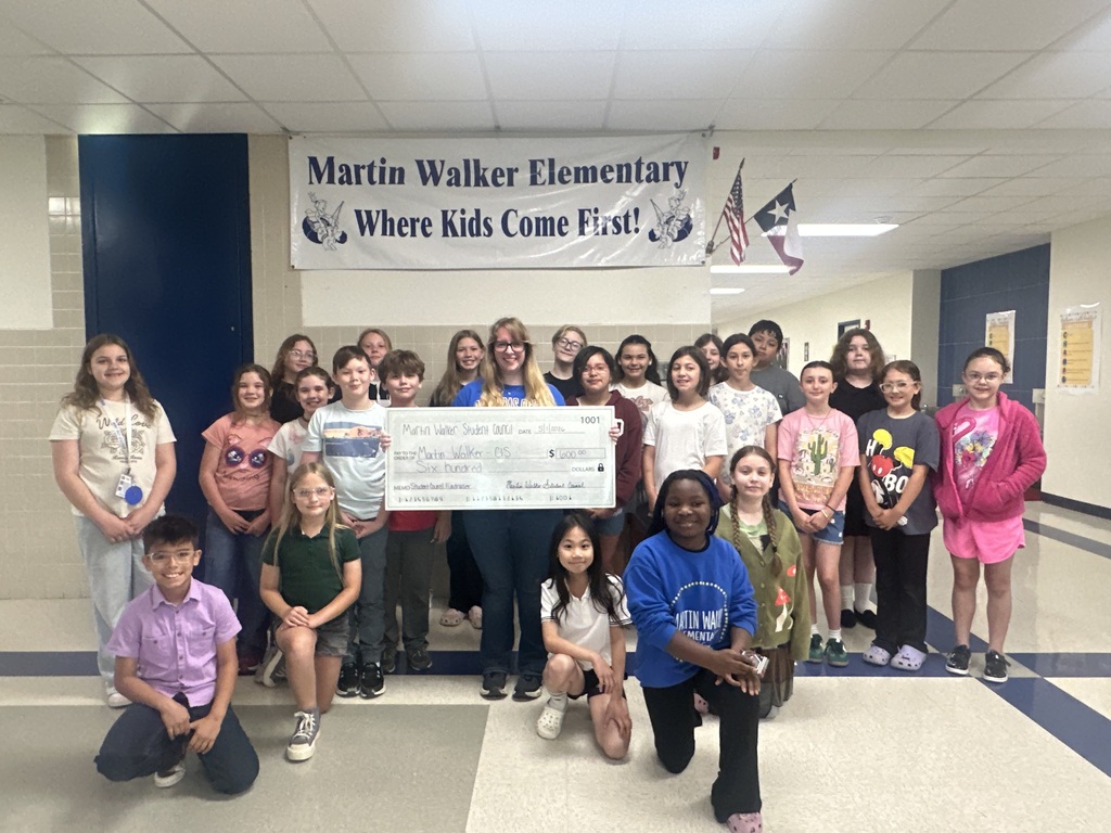 students holding a giant check
