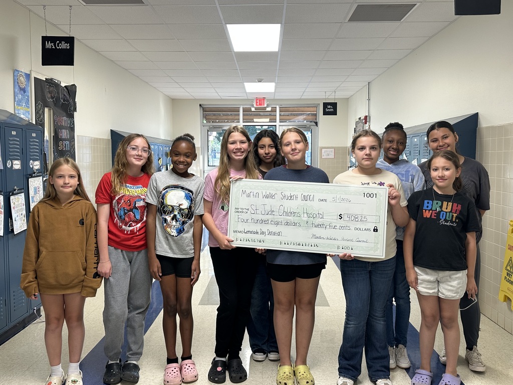 students holding a giant check