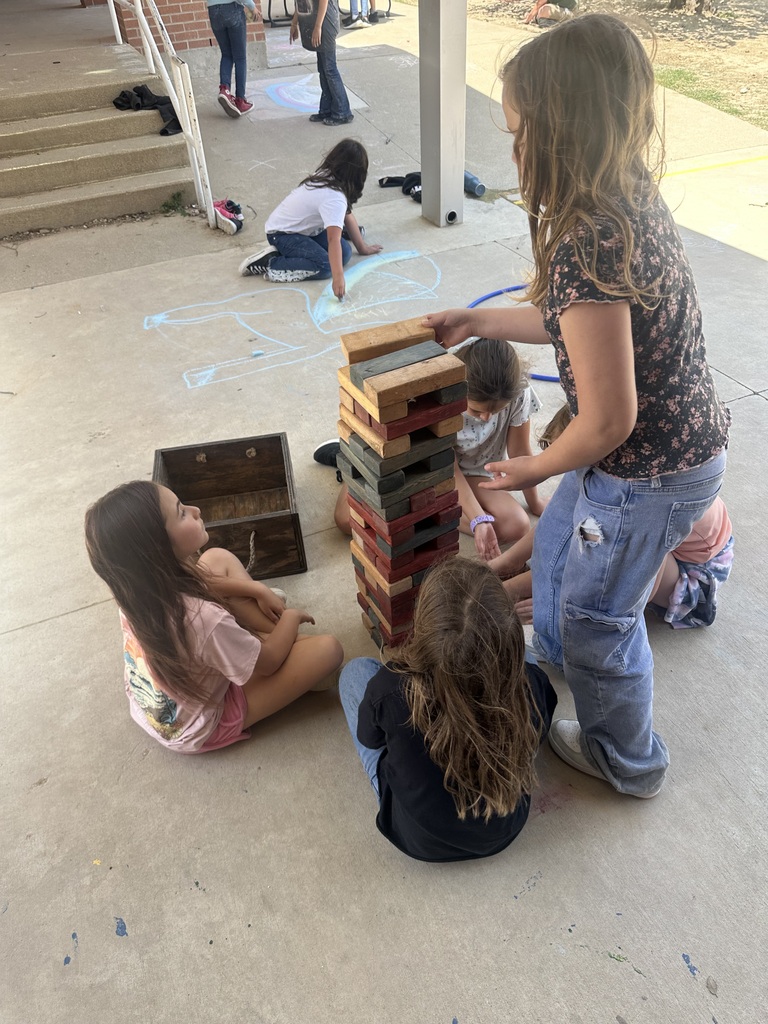 students playing a large game of jenga