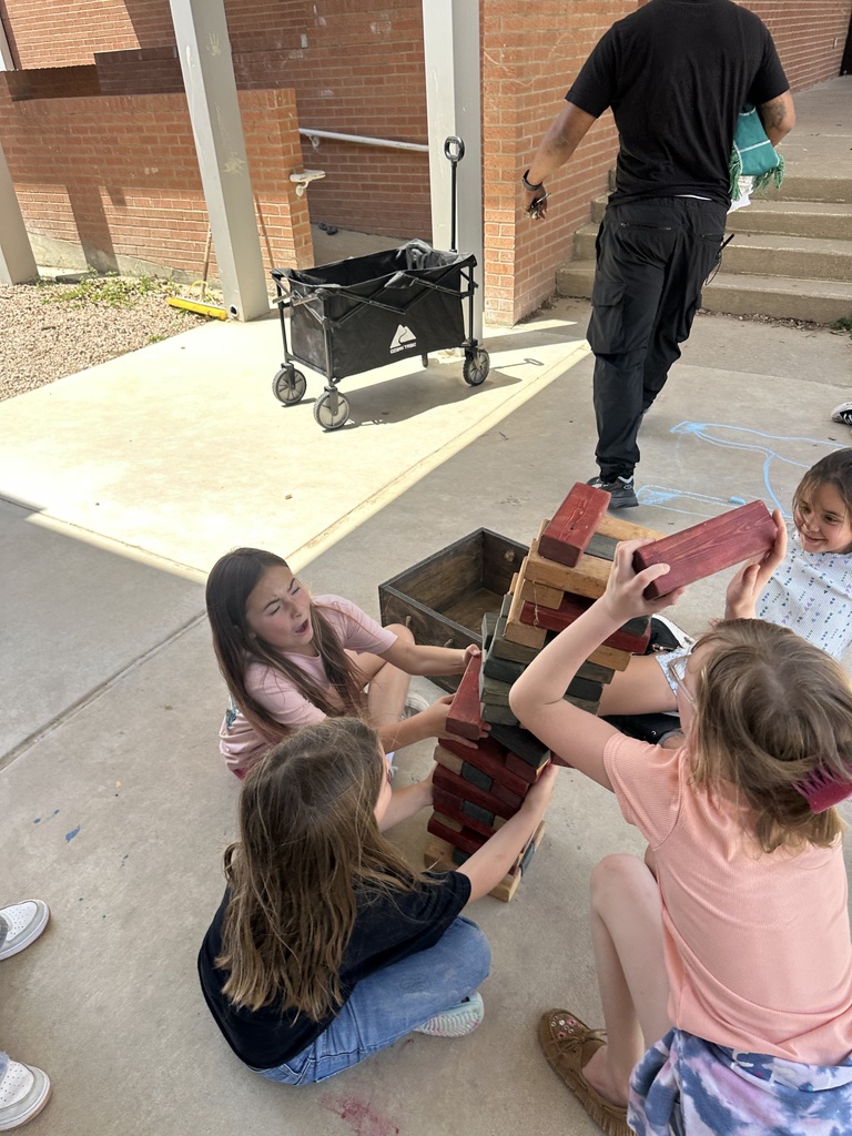 students playing a large game of jenga