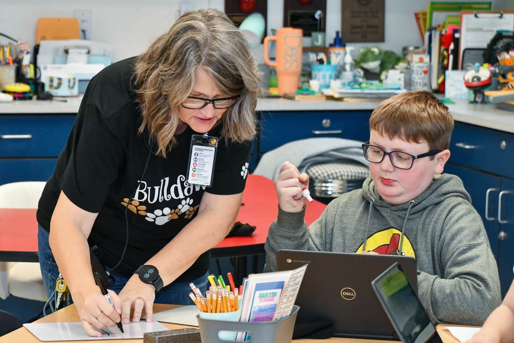 Teacher helping student on a lesson