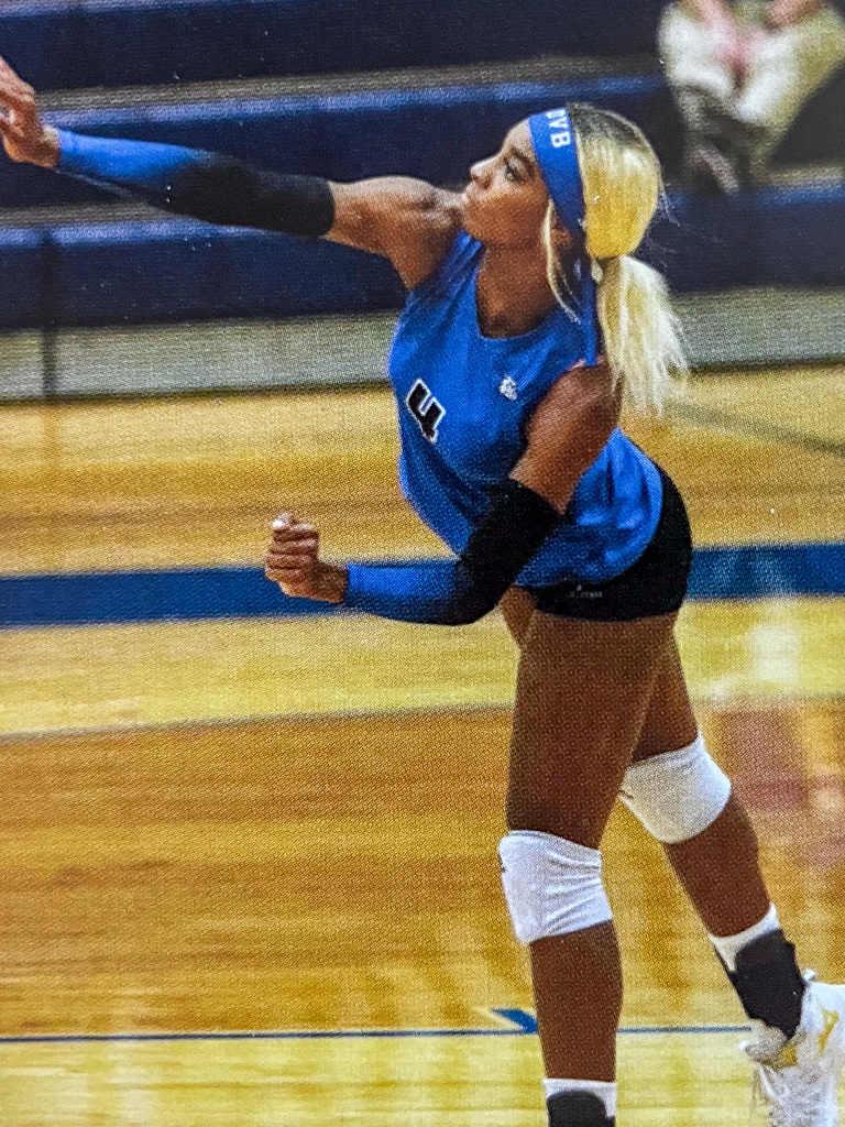 Volleyball player serving ball
