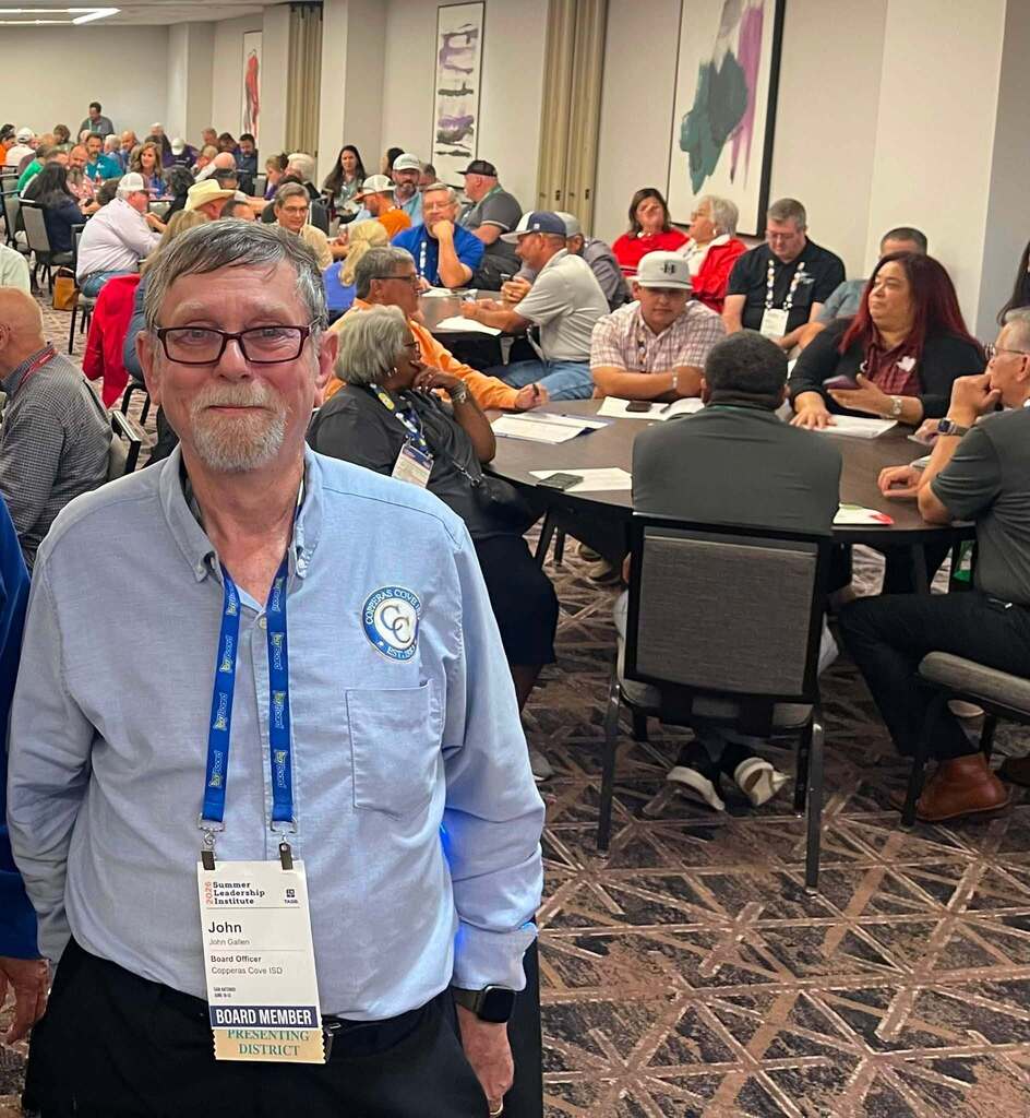 Man smiling in a conference center room