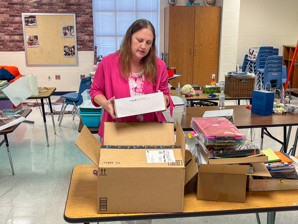 Woman unpacking supplies out of a box