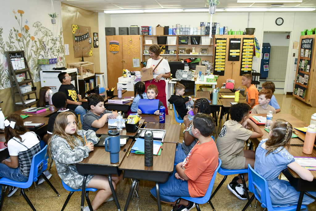 A classroom full of students and a teacher