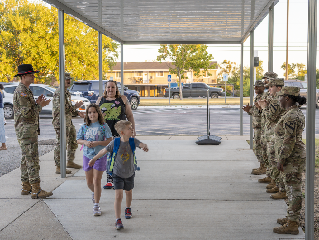 Students walking in as soldiers cheer