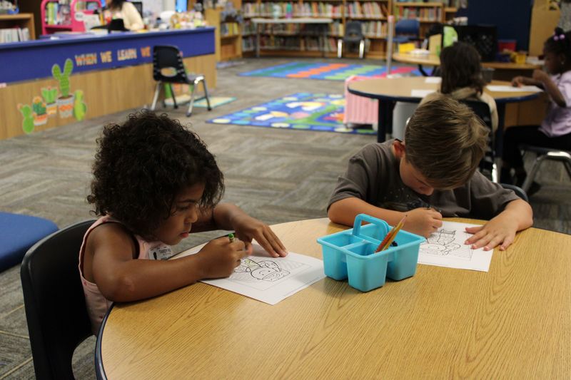 students coloring a picture.