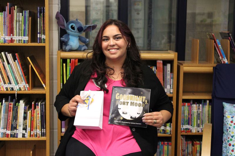 Author MyKala Guerrero with her book Goodnight Fort Hood.