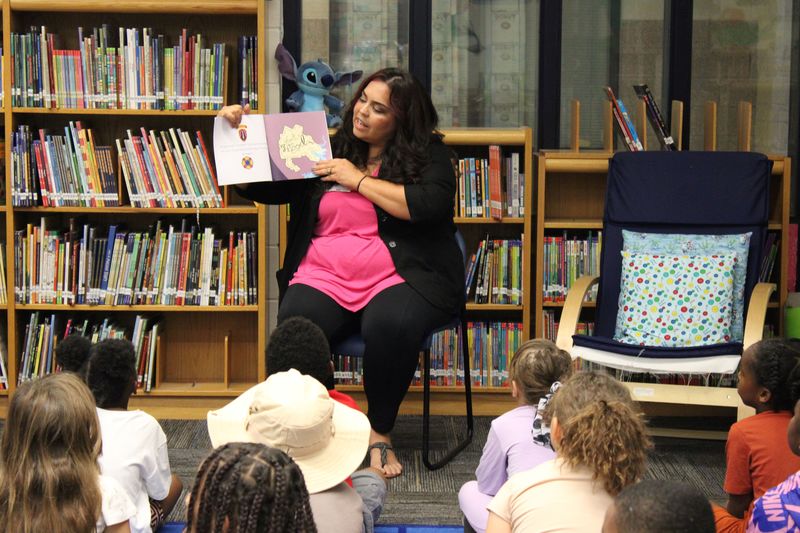 Author MyKala reading her book to students.