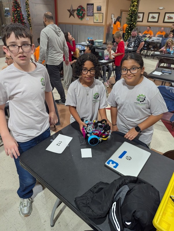 Three students and their robot.
