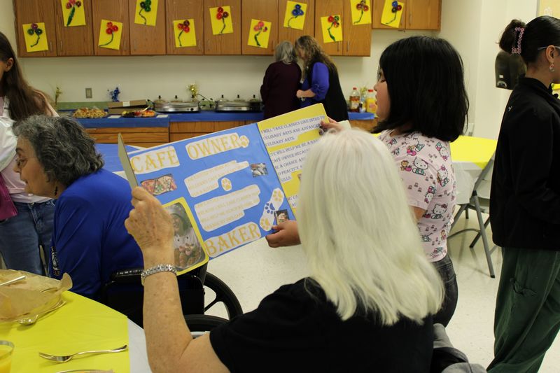 ES2S student presenting to a board member.
