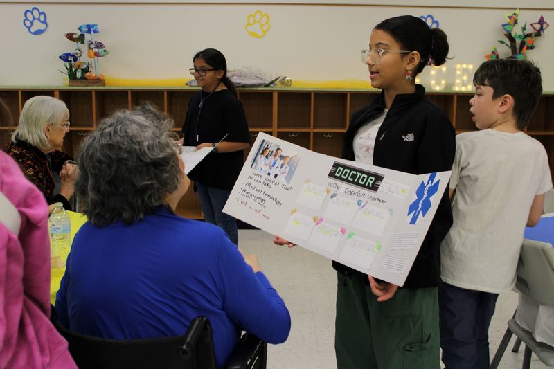 ES2S students presenting to board members.