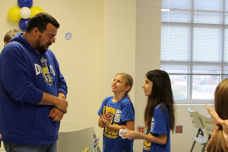 Choir students playing a game a board member.