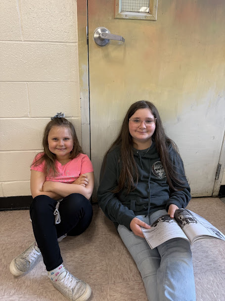 Grades 1 and 6 pen pals read together