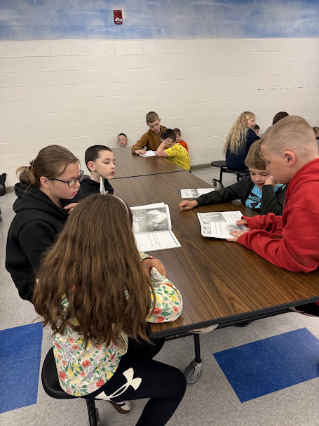 Grades 6 and 1 pen pals read together