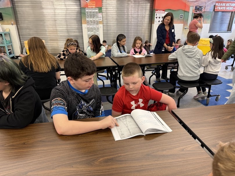 Grades 1 & 6 pen pals read together